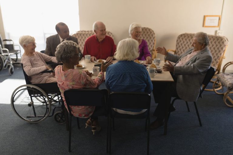 Seniors enjoying conversation and breakfast together in a community setting